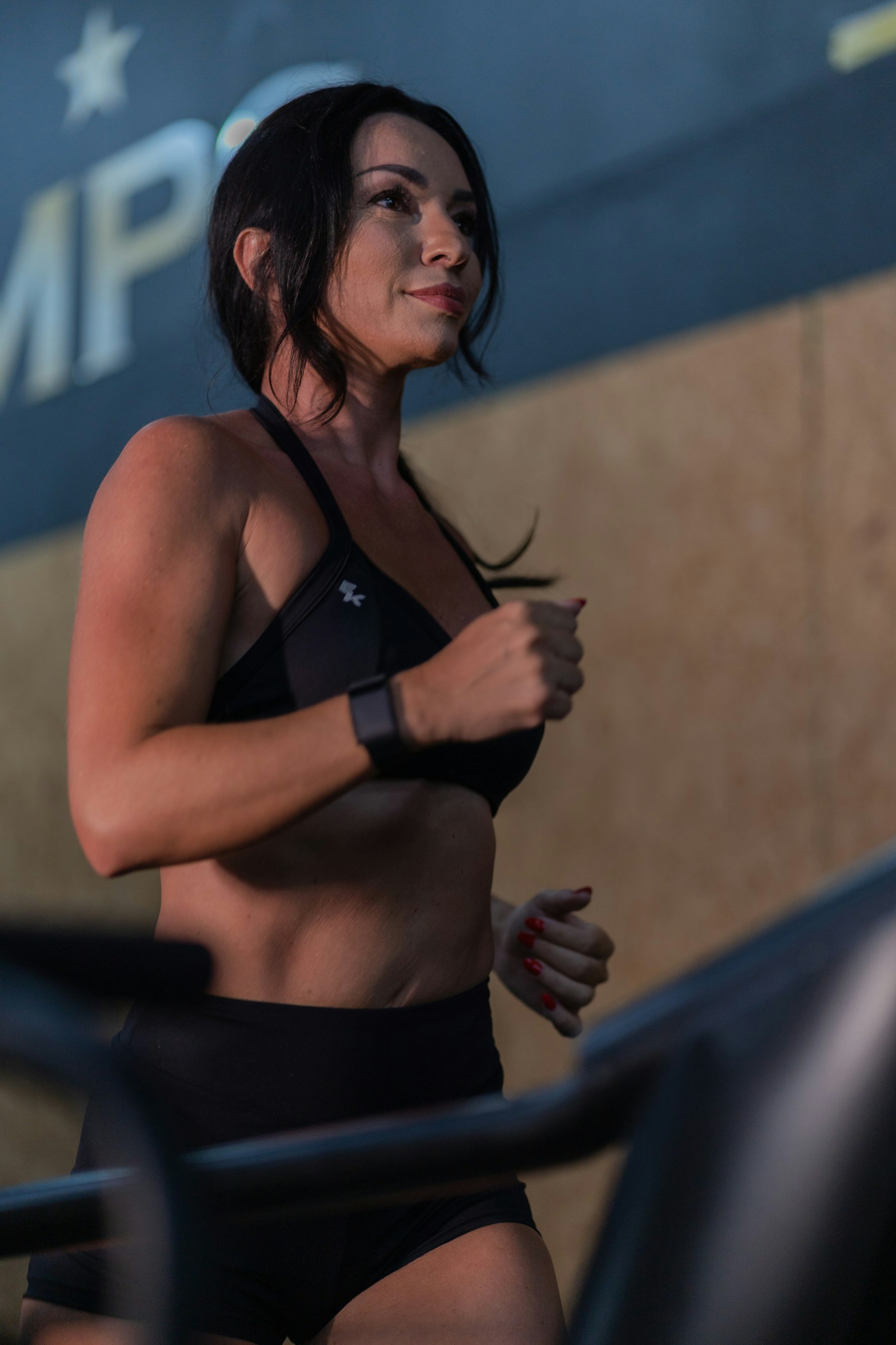 A woman running on a treadmill in a gym