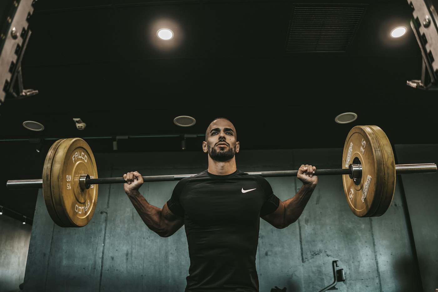 A lifter preparing for a barbell squat in a gym
